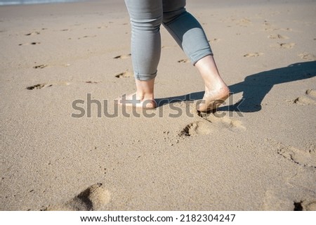 Bare feet on the sand of a beach