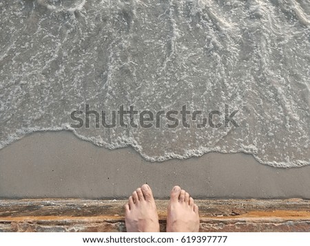 Bare Feet Standing on Cement Edge Near The Sea