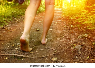 bare feet walking along the forest path close up photo