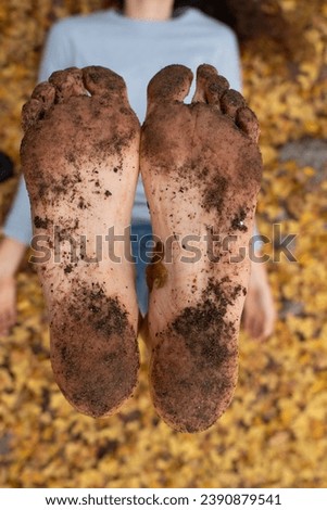 Bare feet of woman with dirt from walking barefoot seen close up
