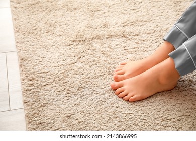 Bare Feet Of Young Woman On Carpet In Bedroom, Closeup