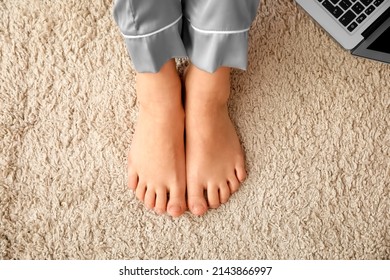 Bare Feet Of Young Woman On Carpet In Bedroom, Closeup