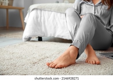 Bare Feet Of Young Woman Resting In Bedroom, Closeup