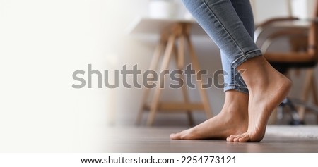 Bare feet of young woman walking at home. Banner for design