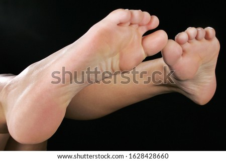 bare female feet isolated on black