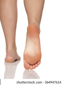 Bare Female Feet On A White Floor