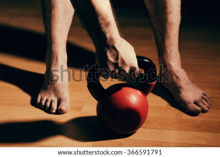 Bare Foot Man Reaching Out For A Weight Preparing For A Workout Session Bare Foot Man Reaching Out For A Weight Preparing For A Workout Session