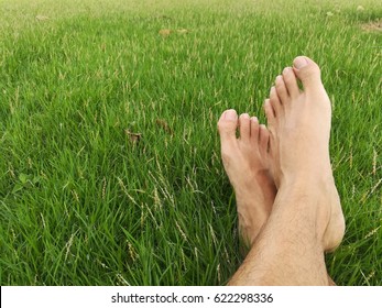 Bare foot on the green grass.relaxing concept