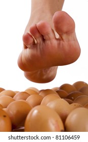 Bare Foot Walking On Egg Shells, White Background.