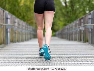 Bare Legs And Shorts Of A Running Woman