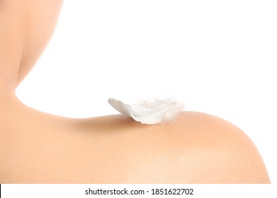 Bare Woman Shoulder With A White Feather On It. Sensitive Skin Concept Isolated On White Background.