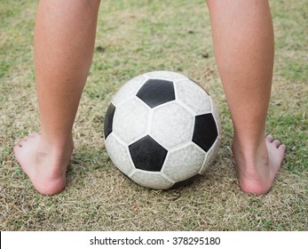 Bared Feet Of Kid On The Soccer Ball