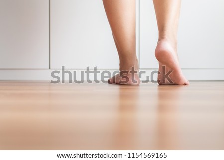 Barefoot asian woman clean and soft skin on the wooden floor