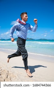 Barefoot Businessman Running Along An Empty Tropical Beach