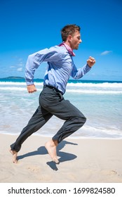 Barefoot Businessman Running Along An Empty Tropical Beach