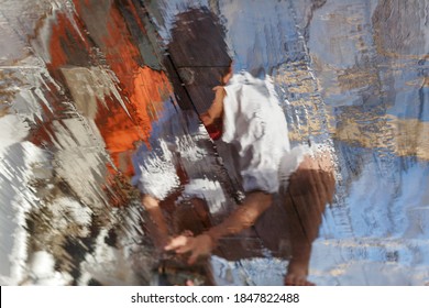 A Barefoot Cadet Scrubbing Wooden Deck With Coconut And His Reflection 