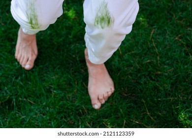 Barefoot female legs on the green grass. focus on the knee contaminated with grass. daily life stain concept. outdoors
 - Shutterstock ID 2121123359