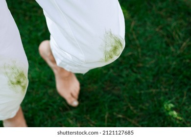 Barefoot Female Legs On The Green Grass. Daily Life Stain Concept. Outdoors