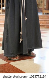 Barefoot Franciscan Friar With Sandals And Brown Habit In The Cathedral