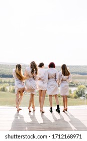 Barefoot Girls Having Fun At A Pyjama Party. Bridesmaids Hugging On Bridal Morning Getting Ready, Before The Wedding Ceremony.