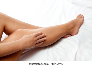 Barefoot And Healthy Legs On White Sheet