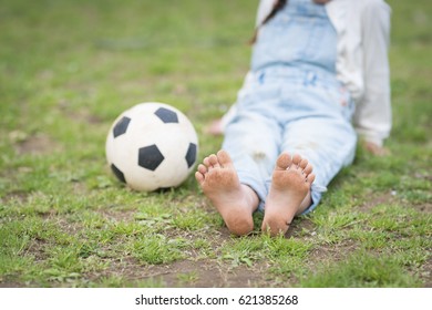 Barefoot Little Girl Playing With A Soccer Ball