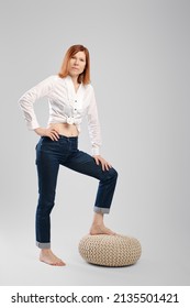 Barefoot Middle Age Woman Step On Padded Stool. Studio Concept Of Carefree Life.