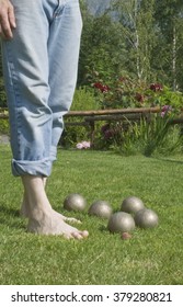 The Barefoot On The Grass Player Observes The Bowls