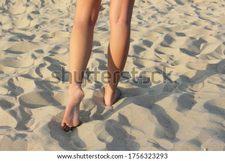 Barefoot on the yellow sand