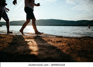 Barefoot Running On The Beach, Family Running Bare Feet On The Beach, Silhouettes Of Feet, Group Of People On The Sandy Beach In Summer