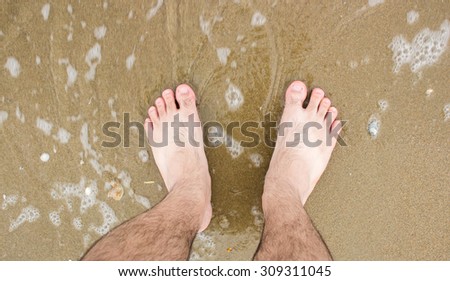 barefoot in sea with foam