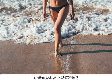 
Barefoot slender female legs walking in the surf. In move.