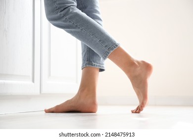 Barefoot woman near counter in kitchen, closeup - Shutterstock ID 2148475913