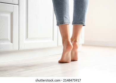 Barefoot Woman Near Counter In Kitchen, Closeup