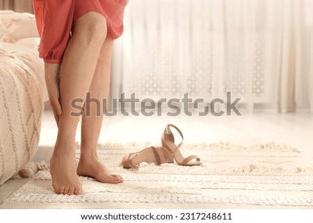 Barefoot woman with varicose veins at home, closeup. Space for text