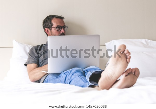 Barefoot Young Man Sitting On Bed Stock Photo Edit Now 1457020088