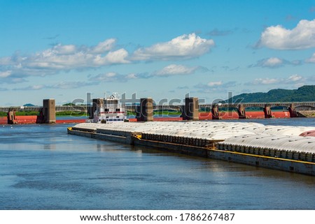 Barge on the Mississippi River on a beautiful Summer morning.  Bellevue, Iowa, USA