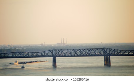 Barge Traveling Down The Mississippi River Under The Harahan Bridge At Memphis, Tennessee.