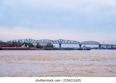 Barges And Tugboat On The Mississippi River Near The Huey P. Long Bridge