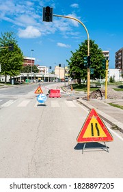 Bari, ITALY - April 20, 2016: Street Construction Zone With Orange Suited Man Directing Traffic With Orange Flag