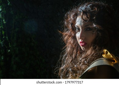 Bari, Puglia/ Italy - July 17 2016: Outdoor Night Ray Of The Moon Illuminates The Face Of A Young And Beautiful Italian Woman Is A Model In The Medieval Fantasy Scene As An Amazon