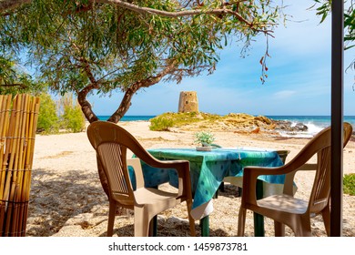 Bari, Sardinia, Italy - A Beautiful Seat By The Sea, Overlooking The Old Round Tower (Torre Di Bari) On The Coast Of Bari, This Is A Historic Place, With Two Beaches, On A Sunny Day In May.