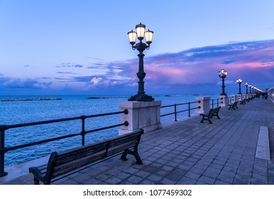 Bari seafront at sunset Purple and blue sky landscape panorama. Bench and street lamp near the sea - Powered by Shutterstock