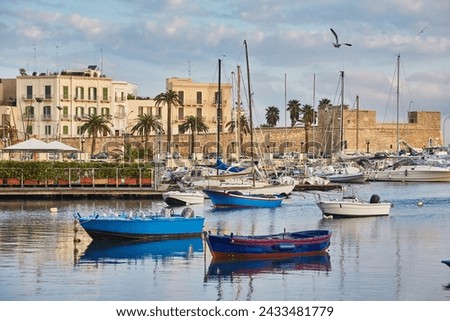 Bari town skyline and fishing boats - harbor in Apulia region, Italy.
