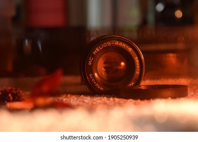 BARILOCHE, ARGENTINA; JANUARY 28, 2021:  Zenit Camera, An Helios Lense, Flowers And 35mm Film In A White Blancket