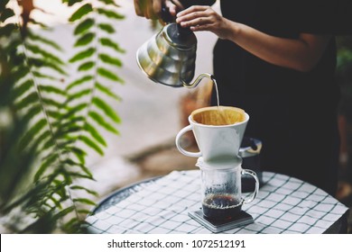 Barista Brewing Coffee, Method Pour Over, Drip Coffee. In The Garden