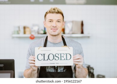 Barista cafe coffee staff hand holding shop Closed sign banner, Restaurant Close or reclosed from Covid-19 lockdown concept - Shutterstock ID 1956122167