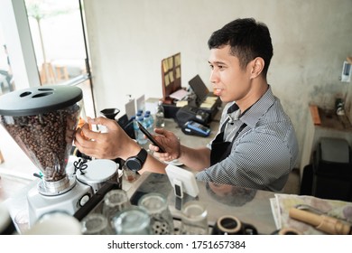 barista checking of coffee machine when using smartphone - Powered by Shutterstock - Get 15% off with code: PIKWIZARD15
