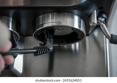 Barista cleaning group heads of coffee machine - Powered by Shutterstock