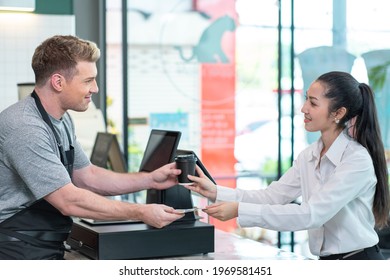 Barista Coffee Maker Sends Customers A Cup Of Coffee With Change To The Customer At The Coffee Shop. 